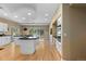 Open-concept kitchen boasts granite countertops, white cabinetry, and modern appliances at 69 N Ranch Rd, Littleton, CO 80127