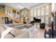 Open-concept living room with high ceilings, natural light, comfortable seating, and grand piano at 69 N Ranch Rd, Littleton, CO 80127