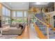 Bright living room featuring a staircase, expansive windows, and stylish, comfortable furnishings at 69 N Ranch Rd, Littleton, CO 80127