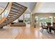 Spacious living room featuring a modern staircase, fireplace, and large windows with natural light at 69 N Ranch Rd, Littleton, CO 80127