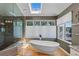 Bright and airy bathroom with soaking tub, large windows, and a separate shower at 69 N Ranch Rd, Littleton, CO 80127