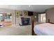 Cozy main bedroom featuring a stone fireplace, and access to the ensuite bathroom at 69 N Ranch Rd, Littleton, CO 80127
