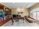 Well-lit office space features built-in shelving, a decorative desk, and a comfortable chaise lounge at 69 N Ranch Rd, Littleton, CO 80127