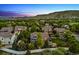 A home's aerial view highlights the backyard, which includes a playset, fire pit, and patio area at 16267 W 59Th Pl, Golden, CO 80403