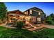 Backyard showcasing a covered patio with outdoor dining and lighting at 16267 W 59Th Pl, Golden, CO 80403