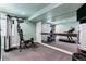 Home gym featuring weight training equipment, treadmill, and mirrors for fitness enthusiasts at 16267 W 59Th Pl, Golden, CO 80403