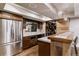 Basement bar area with rustic wood accents, modern appliances and wine storage at 16267 W 59Th Pl, Golden, CO 80403