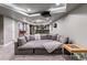 Finished basement with a large sectional sofa, projector and adjacent bar area at 16267 W 59Th Pl, Golden, CO 80403