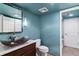 Well-lit bathroom with a modern vessel sink, stylish fixtures and ample storage space at 16267 W 59Th Pl, Golden, CO 80403