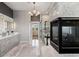Spacious primary bathroom boasts marble tile, modern fixtures, glass enclosed shower, and a cozy fireplace at 16267 W 59Th Pl, Golden, CO 80403
