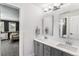 Modern bathroom features double vanity, white countertops, and contemporary mirrors at 16267 W 59Th Pl, Golden, CO 80403