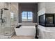 Luxurious bathroom featuring a soaking tub, glass shower, and stylish fixtures at 16267 W 59Th Pl, Golden, CO 80403