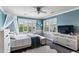 Cozy bedroom featuring a comfortable bed, shuttered windows, and ample natural light at 16267 W 59Th Pl, Golden, CO 80403
