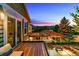 Deck view overlooking outdoor entertaining area with fire pit and sunset views at 16267 W 59Th Pl, Golden, CO 80403