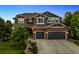 Charming two-story home with brick and siding, three-car garage and well-maintained front lawn at 16267 W 59Th Pl, Golden, CO 80403