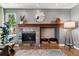 Cozy fireplace with stone surround, wooden mantel and decorative accents in a well lit living space at 16267 W 59Th Pl, Golden, CO 80403