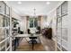 Bright home office with glass-top desk, piano and large window with natural light at 16267 W 59Th Pl, Golden, CO 80403