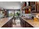 Gourmet kitchen featuring granite countertops, custom cabinetry, and stainless steel appliances at 16267 W 59Th Pl, Golden, CO 80403