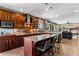 Spacious kitchen with granite countertops, custom cabinets, and a central island with bar seating at 16267 W 59Th Pl, Golden, CO 80403