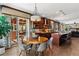 Open-concept kitchen and dining area, complete with dark wood cabinetry and a large island at 16267 W 59Th Pl, Golden, CO 80403