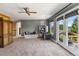 Spacious living room with a ceiling fan, sitting area and access to outdoor living spaces at 16267 W 59Th Pl, Golden, CO 80403