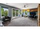 An expansive room with a ceiling fan, doors to the balcony and entertainment options at 16267 W 59Th Pl, Golden, CO 80403