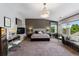 A luxurious main bedroom featuring a fireplace, seating area, and large windows with scenic views at 16267 W 59Th Pl, Golden, CO 80403