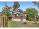 Charming backyard featuring a well-maintained lawn, a fire pit, and a quaint brick home exterior at 3655 Zenobia St, Denver, CO 80212