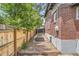 Backyard featuring a wooden fence, brick house and garden boxes at 3655 Zenobia St, Denver, CO 80212