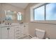 Bathroom featuring double vanity with marble countertop, and large window at 3655 Zenobia St, Denver, CO 80212