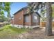 Backyard featuring beautiful brick house, trees, and greenery at 3655 Zenobia St, Denver, CO 80212