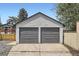 Two-car garage with gray doors and white siding, offering ample parking and storage space at 3655 Zenobia St, Denver, CO 80212