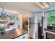 Kitchen view with open access to dining area at 3655 Zenobia St, Denver, CO 80212