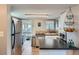 Bright kitchen features stainless appliances, light wood floors, and white cabinets at 3655 Zenobia St, Denver, CO 80212