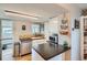 Cozy kitchen features white cabinets, stainless steel appliances, and a breakfast bar at 3655 Zenobia St, Denver, CO 80212