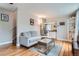 Cozy living room featuring hardwood floors, a comfortable sofa, and an open layout at 3655 Zenobia St, Denver, CO 80212