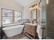 Bathroom featuring a soaking tub, vanity, and glass shower with elegant tile surround at 342 Brook Cir, Boulder, CO 80302