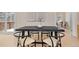 Bright dining room with a black table, seating for four, hardwood floors, and view to snowy deck at 342 Brook Cir, Boulder, CO 80302