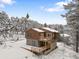 Charming wood home featuring multiple balconies surrounded by snow-covered trees at 342 Brook Cir, Boulder, CO 80302