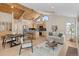 Open concept living room with wood paneled vaulted ceilings, island seating, and a comfortable seating area at 342 Brook Cir, Boulder, CO 80302