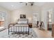 Main bedroom boasts a queen bed, hardwood floors, vaulted ceilings, and views of snow covered trees at 342 Brook Cir, Boulder, CO 80302