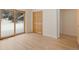 Bright room featuring wood floors, closet, sliding glass doors, and a view of winter at 342 Brook Cir, Boulder, CO 80302