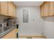 Utility room with laundry sink, overhead cabinets, and water heater at 342 Brook Cir, Boulder, CO 80302