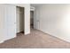Carpeted bedroom with closet with doors and view into another room at 7302 Arkansas Street, Frederick, CO 80530