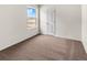 Neutral bedroom featuring a window and a white door at 7302 Arkansas Street, Frederick, CO 80530