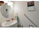 Bathroom with modern fixtures, a pedestal sink, and accessibility features for comfort and convenience at 9207 E Mansfield Ave, Denver, CO 80237