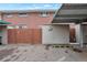 Brick townhouse exterior with assigned parking; neutral shed and well-defined unit number at 9207 E Mansfield Ave, Denver, CO 80237