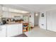 The kitchen features bright white cabinets, a breakfast bar, and easy access to other living spaces at 9207 E Mansfield Ave, Denver, CO 80237