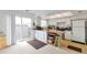 Open kitchen design boasts ample counter space, white cabinetry, and access to a sliding glass door to backyard at 9207 E Mansfield Ave, Denver, CO 80237