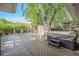 Large wooden deck with outdoor hot tub surrounded by privacy fence and landscaping at 8626 W Utah Ave, Lakewood, CO 80232